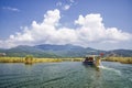 TURKEY, DALYAN, MUGLA - JULY 19, 2016 Pleasure boat with tourists in the mouth of the Dalyan River under Lycian tombs