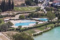 People swim in the pool, view from the height of Pamukkale travertine. Travel in Turkey. Royalty Free Stock Photo