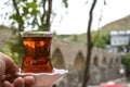 Turkey Diyarbakir by the historical bridge, person drinking tea
