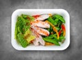 Turkey filet with fresh vegetables. Healthy diet. Takeaway food. Eco packaging. Top view, on a gray background