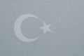 Turkey flag outline on cardboard surface. Paper texture with cellulose fibers. Silver paperboard wallpaper. Light gray tinted