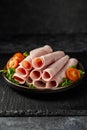 Turkey ham slices in a plate, over dark background Royalty Free Stock Photo