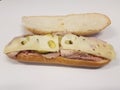 Turkey and ham and swiss sandwich on white surface