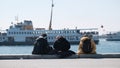 Istanbul bosphorus,sunny day. One man and girls standing on concrete port in Kadikoy Royalty Free Stock Photo