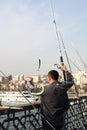 22.10.2016 Turkey, Istanbul - Turkish man catches fish on a bridge in Istanbul Royalty Free Stock Photo