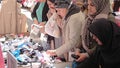 Women shoppers in the Istanbul street market choose goods