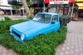 Turkey, Kemer - 08.31.2021: Flowerbed with plants of old car outdoors. Recycling concept. Garden decoration in rustic style
