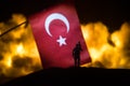 Turkey small flag on burning dark background. Concept of crisis of war and political conflicts between nations. Selective focus