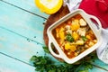 Turkey stew with pumpkin, vegetables and spices in a bowl on a wooden table in a rustic style.