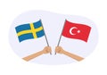 Turkey and Sweden flags. Swedish and Turkish national symbols. Hand holding waving flag. Vector Royalty Free Stock Photo