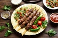 Turkish Adana Kebab with fresh vegetables on flatbread Royalty Free Stock Photo