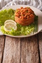 Turkish appetizer spicy kisir of bulgur with herbs on the table.