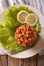 Turkish appetizer spicy kisir of bulgur with herbs on the table.