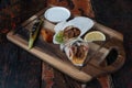 Turkish and Arabic traditional Ramadan Adana kebab roll wrap serving with yogurt and hot pepper on rustic wooden backgrou