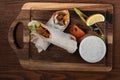 Turkish and Arabic traditional Ramadan Adana kebab roll wrap serving with yogurt and hot pepper on wooden background