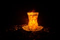 Turkish Azerbaijan tea in traditional glasse and pot on black background with lights and smoke. Armudu traditional cup Royalty Free Stock Photo