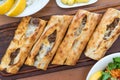 Turkish Bafra Pide with Minced Meat Kavurma Salad and Pickles. Royalty Free Stock Photo
