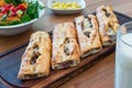 Turkish Bafra Pide with Minced Meat Kavurma Salad and Pickles. Royalty Free Stock Photo