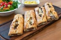 Turkish Bafra Pide with Minced Meat Kavurma Salad and Pickles. Royalty Free Stock Photo