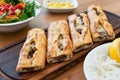 Turkish Bafra Pide with Minced Meat Kavurma Salad and Pickles. Royalty Free Stock Photo