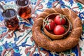 Turkish Bagel Simit with tea and cherry tomatoes on ottoman pattern surface. Royalty Free Stock Photo
