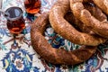 Turkish Bagel Simit with tea on ottoman pattern surface. Royalty Free Stock Photo