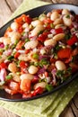 Turkish Bean Salad Piyaz with tomatoes, onions, peppers and cilantro close-up. vertical