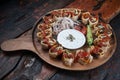 Turkish Beyti kebab served with grilled vegetables and yoghurt sauce on rustic wooden table