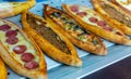 Traditional Turkish pide with various fillings on bakery showcase