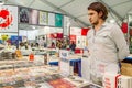 Turkish book seller standing behind the stand in a book fair in Eskisehir, Turkey