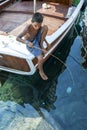 A Turkish boy fishing from a boat.