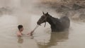 Turkish boy and his horse in thermal water, Guroymak, Bitlis Royalty Free Stock Photo