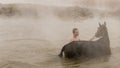 Turkish boy and his horse in thermal water, Guroymak, Bitlis Royalty Free Stock Photo