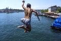 A Turkish boy jumps from Galata Bridge into Golden Horn in Istanbul in Turkey.