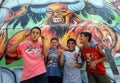 Turkish boys pose in front of a colourful mural at the Mersin amusement park in Turkey.