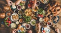 Traditional Turkish breakfast and people taking various food, wide composition