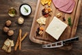 Turkish bryndza sheep milk cheese on wooden table with wooden cutting board and knife Royalty Free Stock Photo