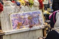 Turkish carpet weaver weaves on a loom on the streets