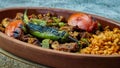 Turkish chicken Kebab called Mudurnu Kebab, garnished with vegetables, bulgur pilaf served on ceramic dish - Turkish,  Food Kebab Royalty Free Stock Photo