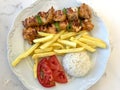 Turkish Chicken Shish Kebab with Rice Pilav or Pilaf Potatoes and Tomato / Sis Kebap. Royalty Free Stock Photo