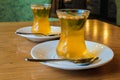 Turkish citrus tea in small cups, with the addition of pine nuts and mint leaves.