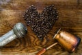 Turkish coffee concept. Copper coffee pot Cezve, vintage coffee grinder, cup, coffee beans on a dark wooden background. Top view Royalty Free Stock Photo