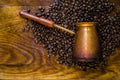 Turkish coffee concept. Copper coffee pot Cezve, vintage coffee grinder, cup, coffee beans on a dark wooden background. Top view Royalty Free Stock Photo