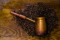 Turkish coffee concept. Copper coffee pot Cezve, vintage coffee grinder, cup, coffee beans on a dark wooden background. Top view Royalty Free Stock Photo