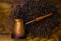 Turkish coffee concept. Copper coffee pot Cezve, vintage coffee grinder, cup, coffee beans on a dark wooden background. Top view Royalty Free Stock Photo