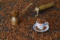 Turkish coffee concept. Copper pot (Cezve), vintage coffee grinder, coffee beans on a dark wooden background. Royalty Free Stock Photo