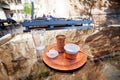 Turkish coffee in copper cezve with a piece of lok