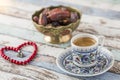 Turkish coffee, dates, and heart shaped rosary on turquoise table