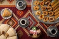 Turkish coffee and sweets served on colorful patterned carpet Royalty Free Stock Photo