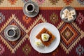 Turkish coffee and sweets served on colorful patterned carpet Royalty Free Stock Photo